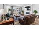 Living room with a fireplace, sliding glass doors to the backyard, and comfortable leather seating at 5670 Pinto Valley St, Parker, CO 80134