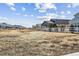 View of neighboring homes and a field with a white fence in a quiet community at 5670 Pinto Valley St, Parker, CO 80134