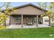Home showcasing a covered patio with a table and chairs, adjacent to a well-maintained lawn at 5670 Pinto Valley St, Parker, CO 80134