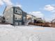 Spacious backyard with a deck and snowy landscape at 3260 Jonquil St, Castle Rock, CO 80109