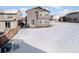 Snow covered backyard with a view of the house at 3260 Jonquil St, Castle Rock, CO 80109