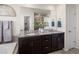 Double vanity bathroom with granite countertop and dark brown cabinets at 3260 Jonquil St, Castle Rock, CO 80109