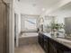 Bathroom with double vanity, granite countertop, and large tub at 3260 Jonquil St, Castle Rock, CO 80109