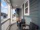 Covered porch with wicker chairs and a view of the street at 3260 Jonquil St, Castle Rock, CO 80109