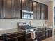 Kitchen features dark cabinetry and granite countertops at 3260 Jonquil St, Castle Rock, CO 80109