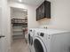 Laundry room with washer, dryer, shelving and cabinets at 3260 Jonquil St, Castle Rock, CO 80109