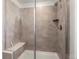 Large walk-in shower with gray tile and built-in seat at 3260 Jonquil St, Castle Rock, CO 80109