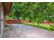 Landscaped backyard featuring a patio, mature trees, and privacy fence at 8563 Redstone St, Highlands Ranch, CO 80126