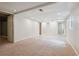 Spacious basement with a carpeted area and bright lighting at 8563 Redstone St, Highlands Ranch, CO 80126