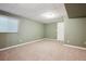 Carpeted bedroom with neutral paint, window and door at 8563 Redstone St, Highlands Ranch, CO 80126