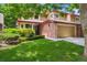 Charming two-story home featuring a brick facade, well-manicured lawn, and mature landscaping at 8563 Redstone St, Highlands Ranch, CO 80126