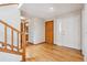 Spacious foyer with hardwood floors, stairs, and access to multiple rooms at 8563 Redstone St, Highlands Ranch, CO 80126