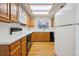 View of kitchen featuring wood cabinets, modern appliances, and bright lighting at 8563 Redstone St, Highlands Ranch, CO 80126