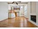 Bright, open living room with hardwood floors, fireplace, and soaring ceilings at 8563 Redstone St, Highlands Ranch, CO 80126