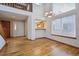 Living room featuring hardwood floors, stairs, and open view to kitchen at 8563 Redstone St, Highlands Ranch, CO 80126