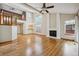 Open-concept living room with hardwood floors, a white brick fireplace, and views of the upper level at 8563 Redstone St, Highlands Ranch, CO 80126