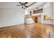 Spacious living room with hardwood floors, stairs leading to an upper level, and natural light at 8563 Redstone St, Highlands Ranch, CO 80126