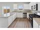 Bright kitchen with granite countertops, stainless steel appliances, and a view to the backyard at 2134 Alyssa St, Fort Lupton, CO 80621