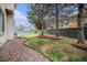 Well-maintained backyard with a lush lawn, rock detail, mature trees, and a privacy fence at 5607 S Gray St, Littleton, CO 80123
