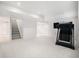 Open basement area with neutral carpet, white walls, and a staircase at 5607 S Gray St, Littleton, CO 80123