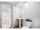 Bathroom with sink, toilet, tiled floor, and an open doorway at 5607 S Gray St, Littleton, CO 80123