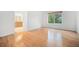 Bright bedroom featuring hardwood floors, a large window, and fresh white walls at 5607 S Gray St, Littleton, CO 80123