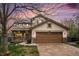 Charming two-story home with a two car garage and a covered front porch at dusk at 5607 S Gray St, Littleton, CO 80123