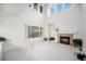 Bright and airy living room with a fireplace, tall windows, and ample natural light at 5607 S Gray St, Littleton, CO 80123