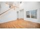 Bright living room featuring high ceilings, hardwood floors, and a staircase at 5607 S Gray St, Littleton, CO 80123