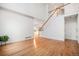 Spacious living room with hardwood floors and a grand staircase leading to the upper level at 5607 S Gray St, Littleton, CO 80123