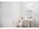 Simple powder room with pedestal sink, toilet, and neutral finishes at 5607 S Gray St, Littleton, CO 80123