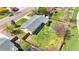 An aerial view of the home with its new gray roof, landscaping, large yard, and a fenced-in backyard with a greenhouse at 5747 W Elmhurst Ave, Littleton, CO 80128