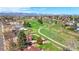 Aerial view of neighborhood with parks and walking path. Mountain views and mature trees add to beauty at 5747 W Elmhurst Ave, Littleton, CO 80128
