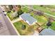 Aerial view of the home's new gray roof, landscaping, driveway, large yard, greenhouse, playset, and fenced backyard at 5747 W Elmhurst Ave, Littleton, CO 80128