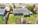 An aerial view of the home with its new gray roof, landscaping, yard and fenced backyard with a greenhouse at 5747 W Elmhurst Ave, Littleton, CO 80128