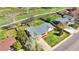 An aerial view of the home with its new gray roof, landscaping, long driveway, spacious yard and a backyard greenhouse at 5747 W Elmhurst Ave, Littleton, CO 80128