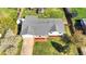 Aerial view of a home with a new gray roof, nice landscaping, a long driveway, a spacious yard, and a backyard greenhouse at 5747 W Elmhurst Ave, Littleton, CO 80128