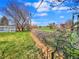 View of a large backyard showing a garden, playset, and walking path to a greenhouse at 5747 W Elmhurst Ave, Littleton, CO 80128