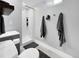 This bathroom offers a walk-in shower, a gray vanity with a modern sink, and hooks for hanging towels at 5747 W Elmhurst Ave, Littleton, CO 80128
