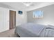 This bright bedroom offers a ceiling fan, a large window, neutral paint and carpet, and a closet with bi-fold doors at 5747 W Elmhurst Ave, Littleton, CO 80128