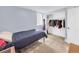 This bedroom offers a large closet, a modern light fixture, a twin bed, a window, and a neutral carpet at 5747 W Elmhurst Ave, Littleton, CO 80128