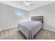 Minimalist bedroom with neutral walls and flooring, and a cozy bed at 5747 W Elmhurst Ave, Littleton, CO 80128