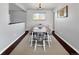 Formal dining area featuring wood-look floors, a large table with seating, and a window at 5747 W Elmhurst Ave, Littleton, CO 80128