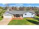 Charming single-story home with manicured lawn and welcoming front porch seating area at 5747 W Elmhurst Ave, Littleton, CO 80128
