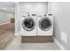 The laundry room includes a side-by-side washer and dryer for laundry convenience at 5747 W Elmhurst Ave, Littleton, CO 80128