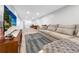 The comfortable living room includes a plush couch and a large television for endless entertainment at 5747 W Elmhurst Ave, Littleton, CO 80128