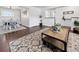 Open-concept living area with wood-look flooring and seamless flow into the adjacent dining space at 5747 W Elmhurst Ave, Littleton, CO 80128