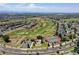 Stunning aerial view of a community with a golf course, tennis courts, and well-maintained landscaping at 11973 Song Bird Hills St, Parker, CO 80138