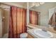 Functional bathroom featuring a shower stall with glass door, vanity, and neutral tile at 11973 Song Bird Hills St, Parker, CO 80138