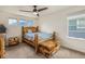 Charming bedroom featuring a wood frame bed and side tables, with three windows at 11973 Song Bird Hills St, Parker, CO 80138